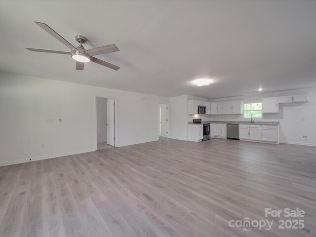 1241 Pitts Rd, Chester, SC 29706 - unfurnished living room with baseboards, a sink, light wood-style floors, and ceiling fan
