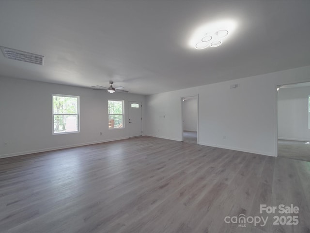 1241 Pitts Rd, Chester, SC 29706 - unfurnished living room featuring ceiling fan, baseboards, light wood finished floors, and visible vents