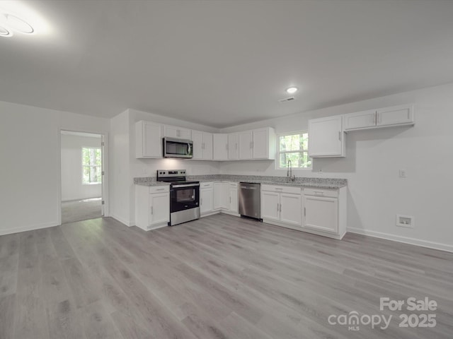 1241 Pitts Rd, Chester, SC 29706 - kitchen featuring white cabinets, baseboards, stainless steel appliances, and a sink