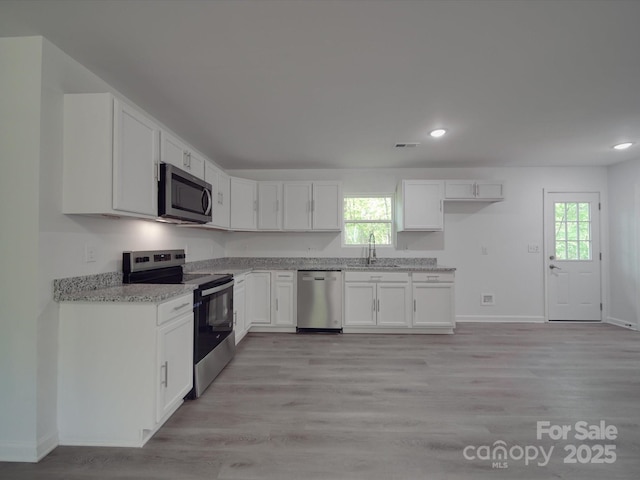 1241 Pitts Rd, Chester, SC 29706 - kitchen featuring light stone counters, a sink, white cabinetry, appliances with stainless steel finishes, and recessed lighting