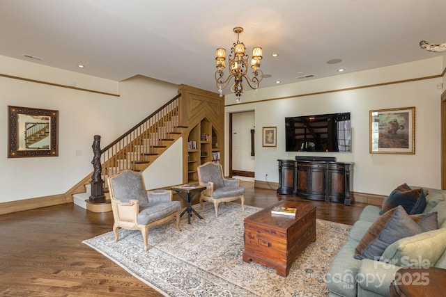 living area with stairway, wood finished floors, a chandelier, baseboards, and visible vents