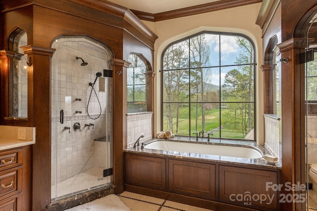 full bath with toilet, decorative columns, and a stall shower