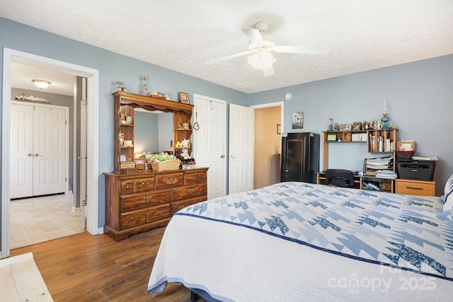 54 Golddigger Dr, Candler, NC 28715 - bedroom with a textured ceiling, a ceiling fan, and wood finished floors