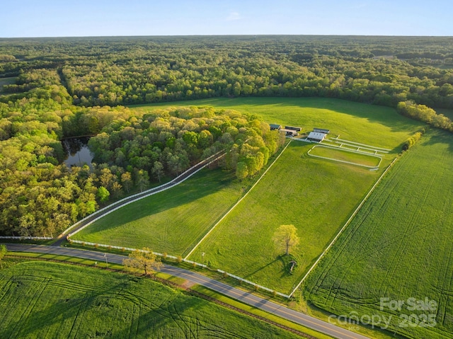 aerial view with a wooded view and a rural view