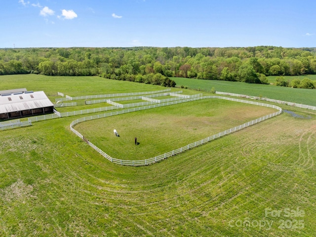 birds eye view of property with a rural view and a wooded view