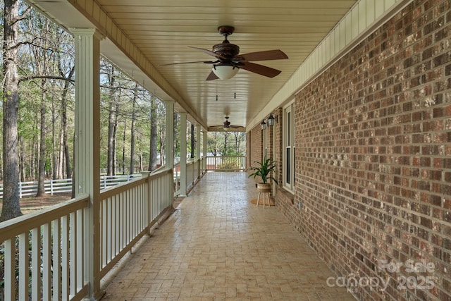 view of patio / terrace with fence and a ceiling fan