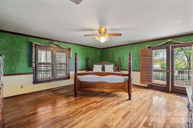 bedroom with access to outside, crown molding, and wood finished floors