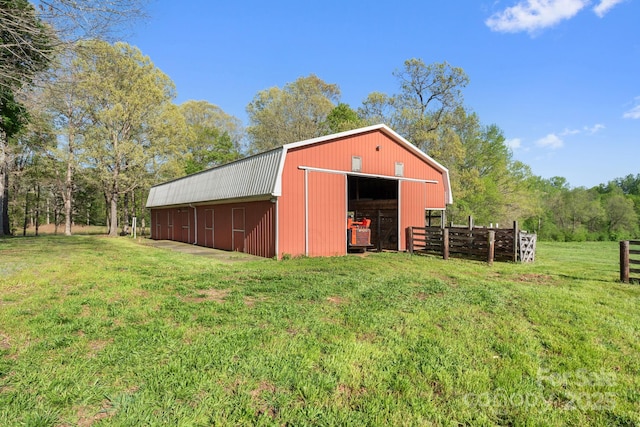view of pole building with a yard and fence