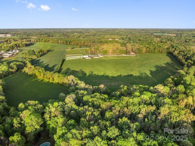 drone / aerial view featuring a wooded view