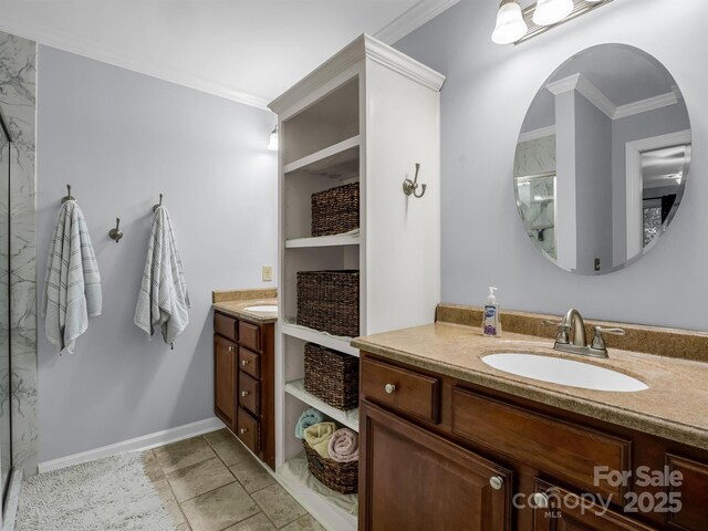 full bathroom featuring crown molding, vanity, baseboards, and a marble finish shower