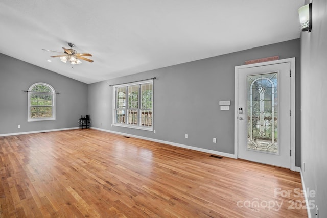 interior space with light wood-style floors, ceiling fan, and a wealth of natural light