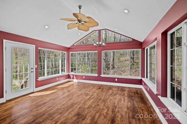 unfurnished sunroom with baseboards, wood finished floors, a deck, and vaulted ceiling