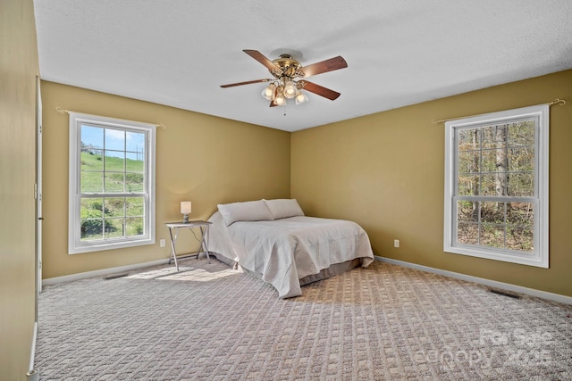 bedroom with baseboards, visible vents, and carpet floors