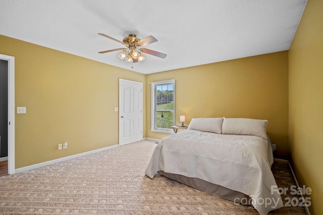 carpeted bedroom with baseboards and ceiling fan