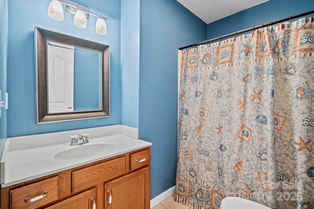 full bathroom with toilet, tile patterned floors, curtained shower, and vanity