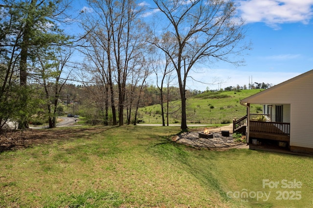 view of yard with a fire pit