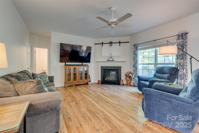 3040 Sunshower Hts, York, SC 29745 - living room featuring light wood finished floors, a ceiling fan, baseboards, and a fireplace with flush hearth