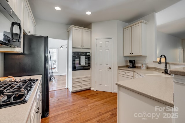 3040 Sunshower Hts, York, SC 29745 - kitchen with recessed lighting, a sink, light wood-style floors, black appliances, and a peninsula