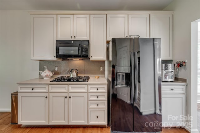 3040 Sunshower Hts, York, SC 29745 - kitchen featuring black appliances, tasteful backsplash, light wood-style flooring, and light countertops