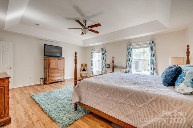3040 Sunshower Hts, York, SC 29745 - bedroom with light wood-type flooring, baseboards, a ceiling fan, and a tray ceiling