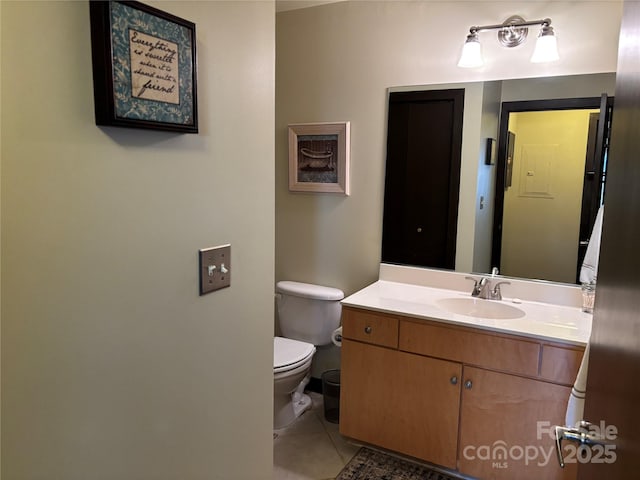 bathroom featuring tile patterned floors, vanity, and toilet