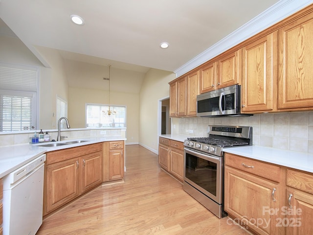126 Dairy Farm Rd, Mooresville, NC 28115 - kitchen with appliances with stainless steel finishes, light wood finished floors, a sink, and backsplash