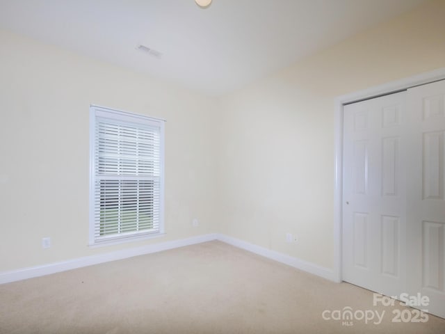 126 Dairy Farm Rd, Mooresville, NC 28115 - unfurnished bedroom with a closet, light colored carpet, baseboards, and visible vents