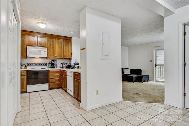 800 Meadowview Dr Unit # 2, Boone, NC 28607 - kitchen featuring white appliances, a textured ceiling, light tile patterned floors, light countertops, and brown cabinets