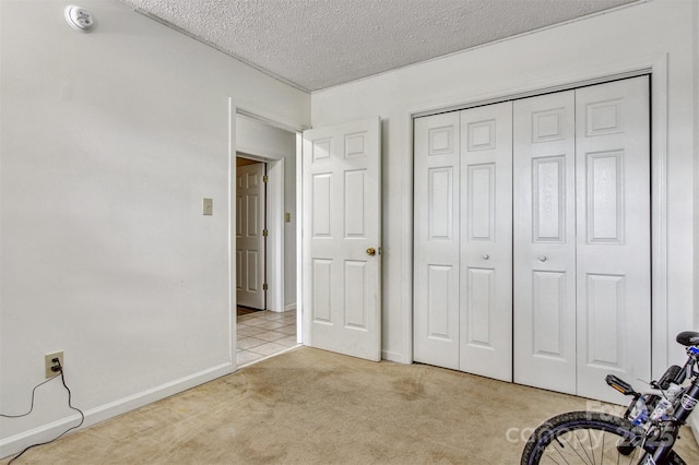 800 Meadowview Dr Unit # 2, Boone, NC 28607 - unfurnished bedroom featuring carpet flooring, a textured ceiling, a closet, and baseboards