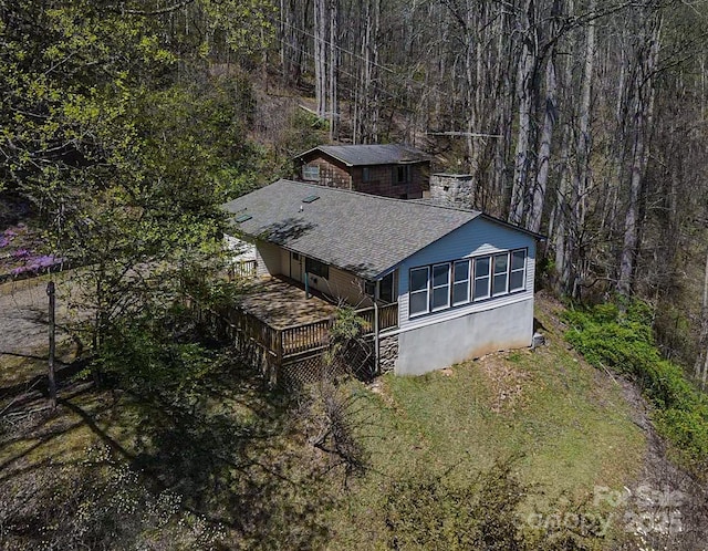 birds eye view of property with a forest view