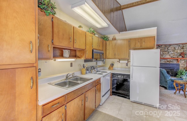 kitchen with white appliances, light tile patterned floors, light countertops, brown cabinets, and a sink