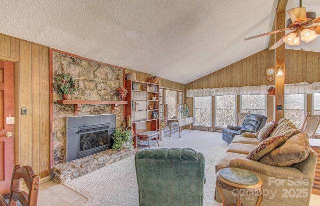 living area with wood walls, a textured ceiling, and lofted ceiling
