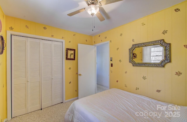 bedroom featuring a closet, light colored carpet, and a ceiling fan