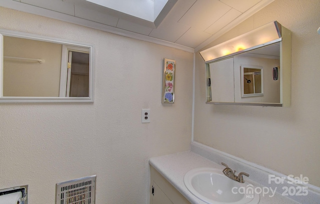 bathroom featuring vanity, heating unit, and lofted ceiling