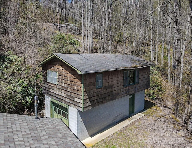 view of outdoor structure featuring a forest view