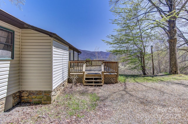 exterior space with a deck with mountain view