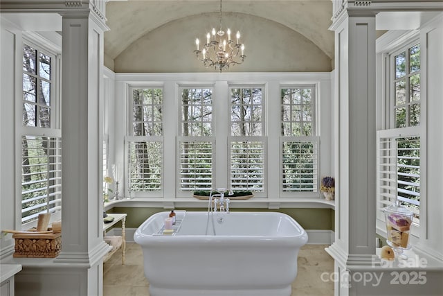 205 W Indrio Rd, Blowing Rock, NC 28605 - full bath with ornate columns, vaulted ceiling, a freestanding tub, a chandelier, and healthy amount of natural light