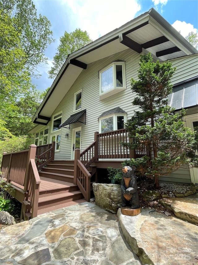 rear view of property featuring a deck