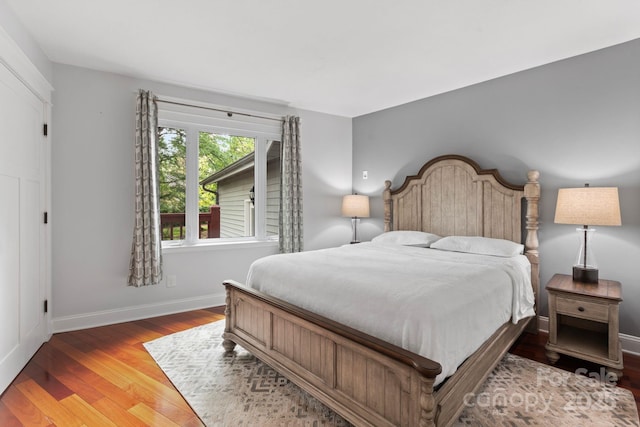 bedroom featuring baseboards and wood finished floors