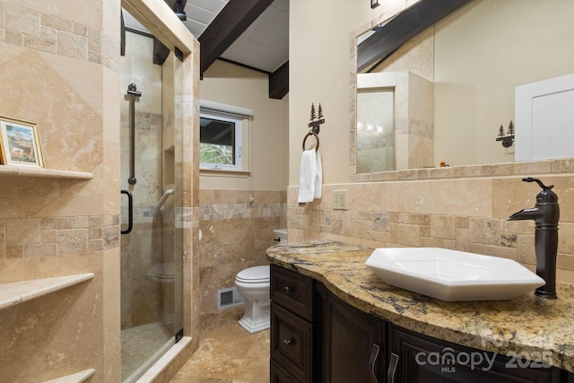 full bath featuring tile walls, vaulted ceiling with beams, a shower stall, and visible vents