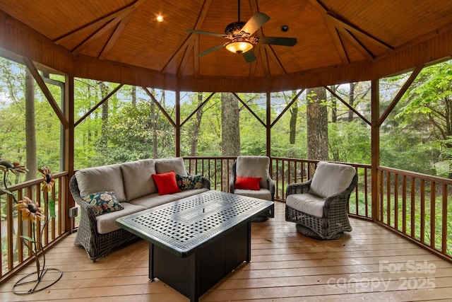 wooden deck featuring a gazebo, an outdoor hangout area, and ceiling fan