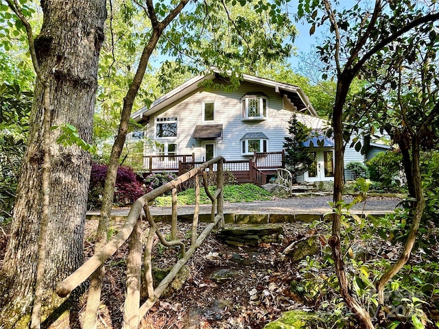 rear view of property with a wooden deck