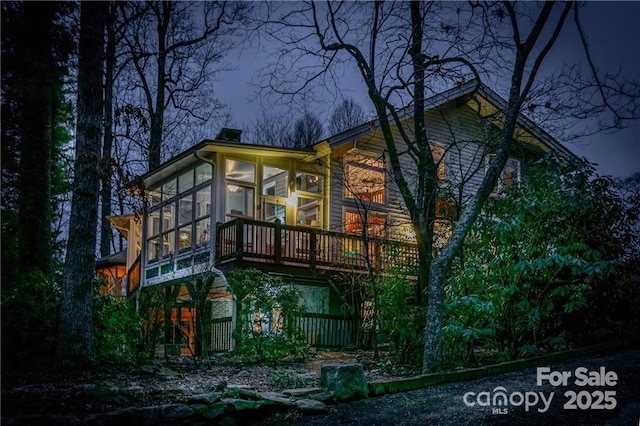 back of house with a sunroom