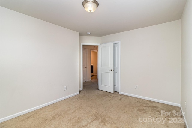 unfurnished bedroom with baseboards and carpet