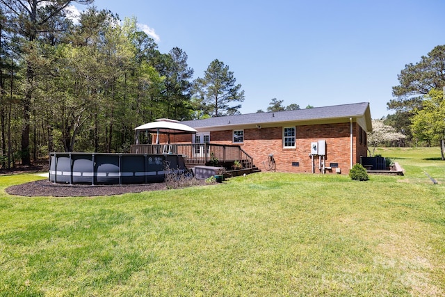 5381 Mount Carmel Rd, Heath Springs, SC 29058 - rear view of house with brick siding, a gazebo, a lawn, and an outdoor pool