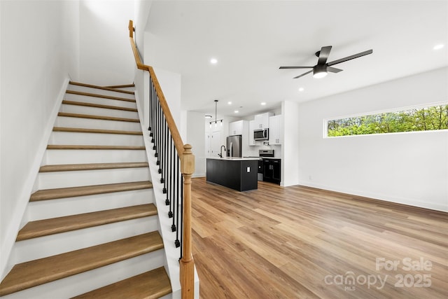 2043 Greenoak Dr, Shelby, NC 28152 - stairs with recessed lighting, a ceiling fan, wood finished floors, and baseboards