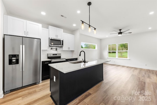 2043 Greenoak Dr, Shelby, NC 28152 - kitchen with a sink, light wood-type flooring, appliances with stainless steel finishes, a ceiling fan, and recessed lighting