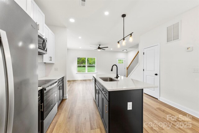 2043 Greenoak Dr, Shelby, NC 28152 - kitchen with ceiling fan, white cabinets, visible vents, a sink, and stainless steel appliances