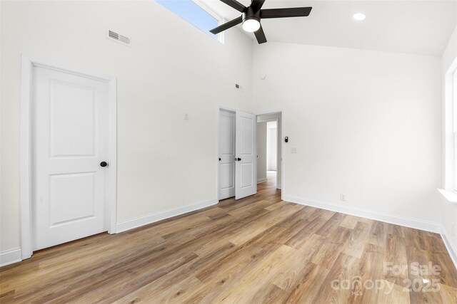 2043 Greenoak Dr, Shelby, NC 28152 - unfurnished bedroom featuring light wood-style floors, visible vents, a high ceiling, and baseboards