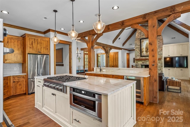 92 Gobblers Neck Dr, Nebo, NC 28761 - kitchen featuring a center island, recessed lighting, stainless steel appliances, vaulted ceiling with beams, and beverage cooler